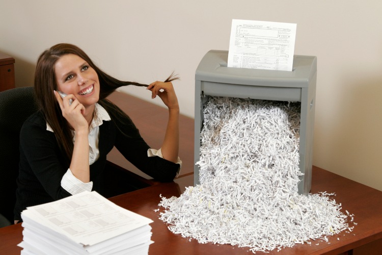 a woman shredding papers in an office at georgia and florida